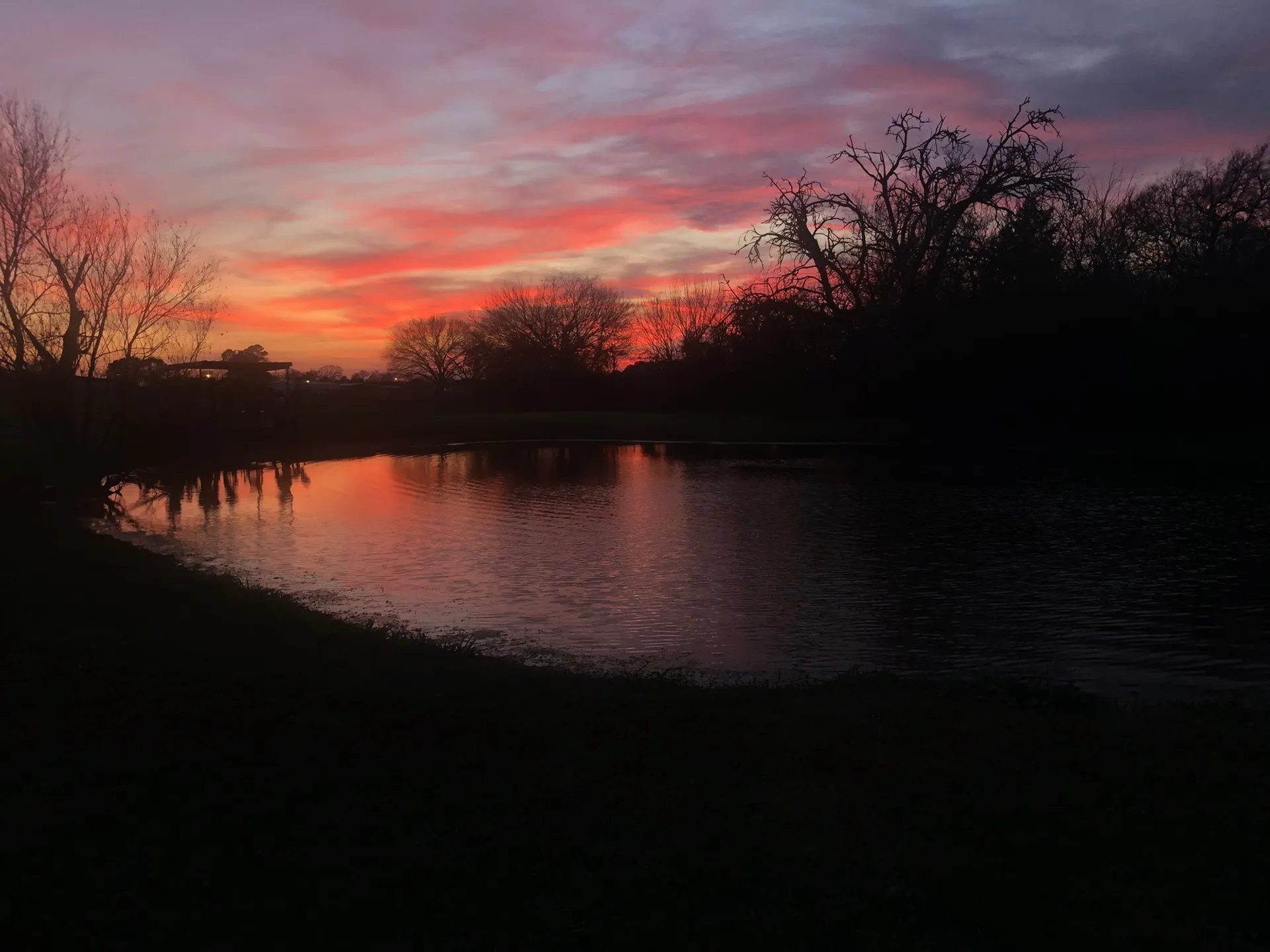 Sunset reflected in the pond · Waggin' Tail Ranch RV Resort, Pilot Point, Texas