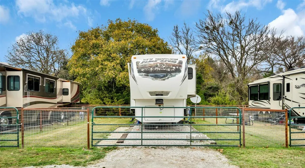 A fenced back-in RV site · Waggin' Tail Ranch RV Resort, Pilot Point, Texas